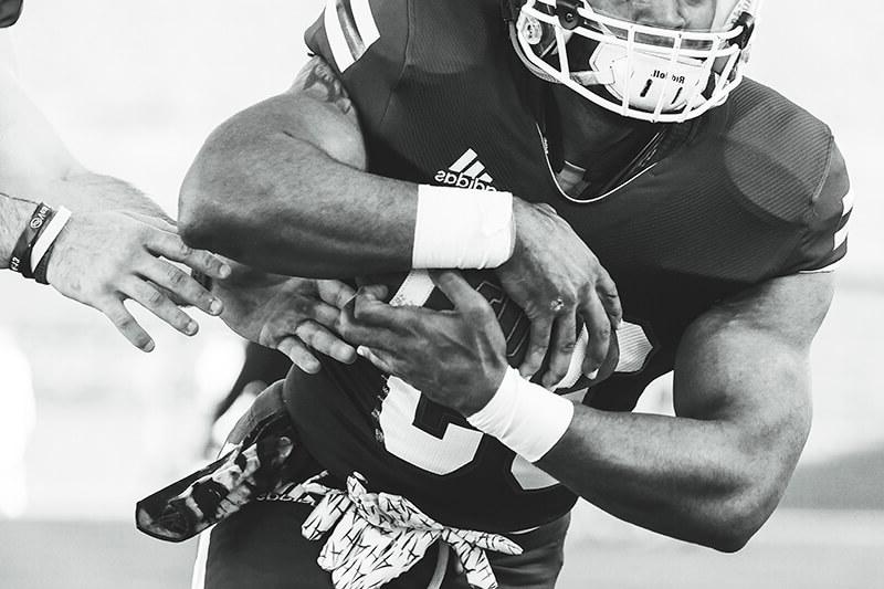 closeup of 博彩平台推荐 Wolves football player holding a football